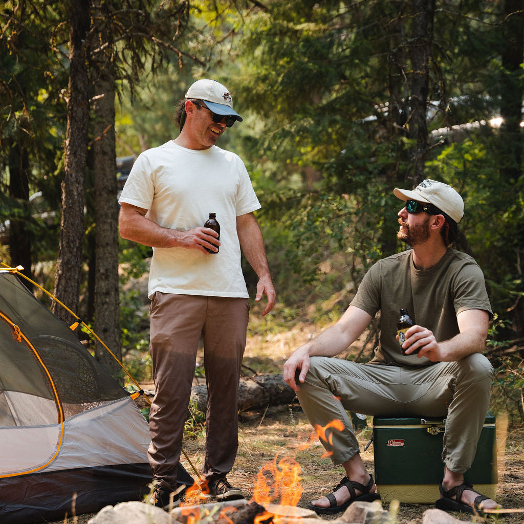 Man wearing white Mad Trapper Standard Issue Tee at campsite